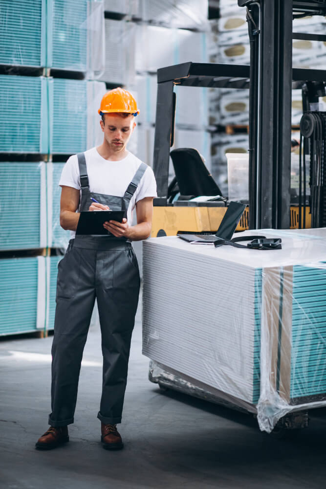 young-man-working-warehouse-with-boxes